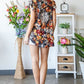 Heimish Full Size Ruffled Floral Round Neck Cap Sleeve Blouse